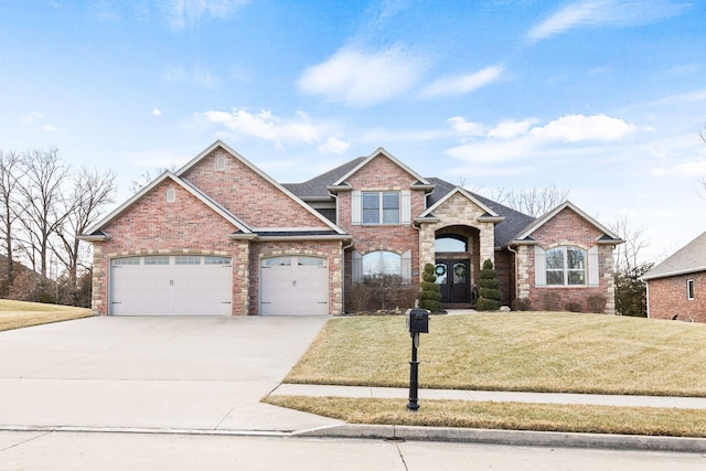 view of front of house featuring a garage, a front yard, brick siding, and driveway