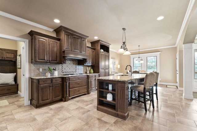 kitchen featuring dark brown cabinetry, a breakfast bar, gas stovetop, open shelves, and backsplash