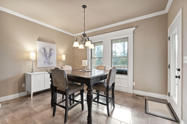 dining room featuring a chandelier, ornamental molding, visible vents, and baseboards