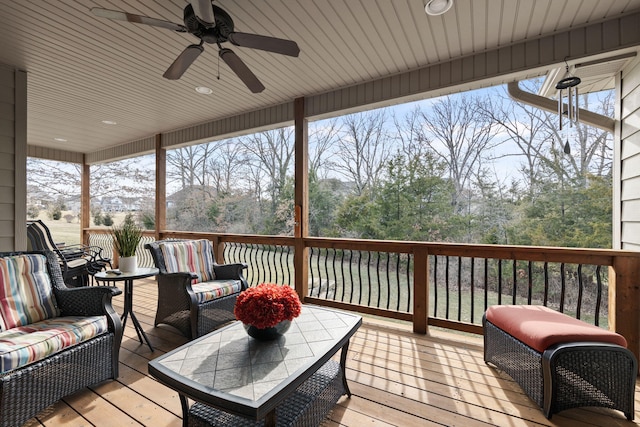 wooden deck with a ceiling fan and an outdoor hangout area