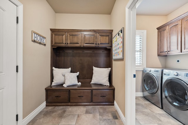 washroom with cabinet space, visible vents, baseboards, and independent washer and dryer