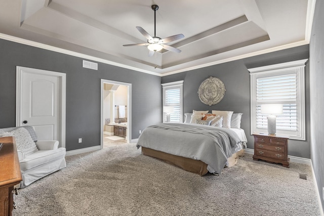 carpeted bedroom featuring ornamental molding, a raised ceiling, visible vents, and baseboards