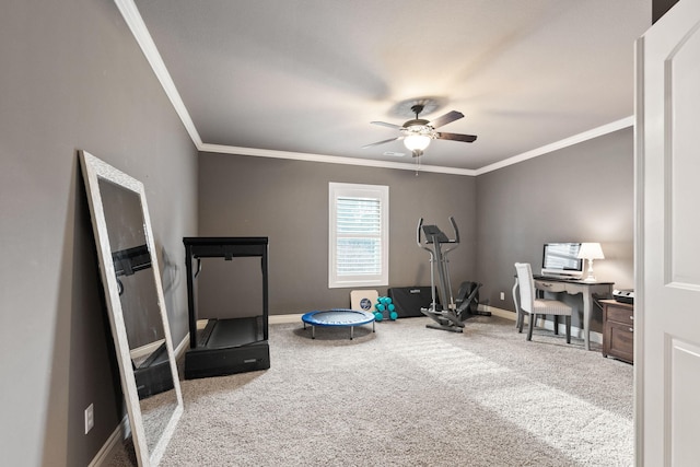 workout area with ornamental molding, carpet, a ceiling fan, and baseboards