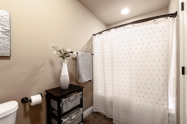 full bathroom with a shower with shower curtain, toilet, and tile patterned floors