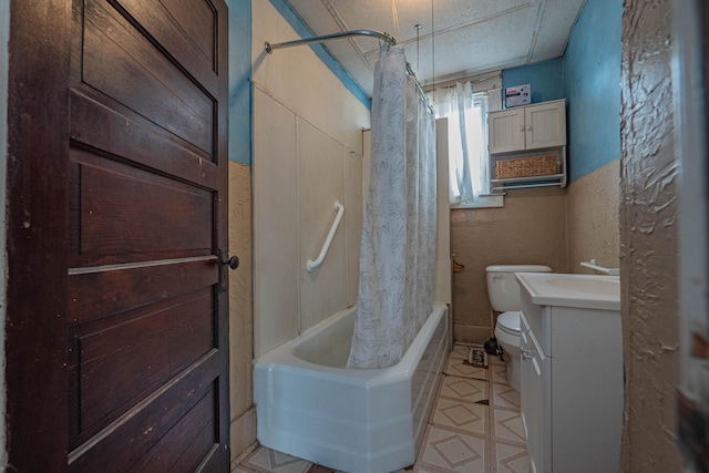 full bath with a textured wall, vanity, toilet, and shower / bath combo with shower curtain