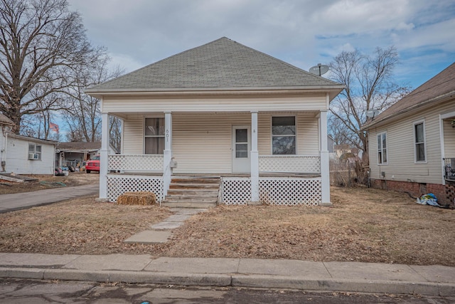 view of front of property with covered porch and roof with shingles