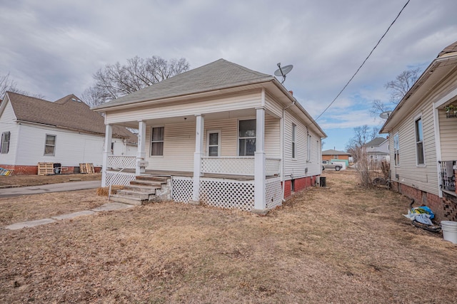 view of front of property with covered porch and roof with shingles