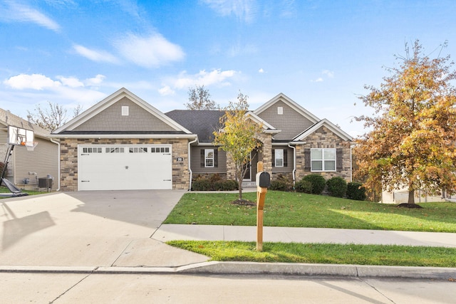 craftsman-style home with central air condition unit, a front yard, a garage, stone siding, and driveway