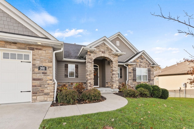 craftsman house with an attached garage, stone siding, a shingled roof, and a front yard