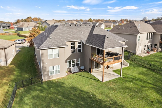 rear view of house featuring a lawn, a patio area, and a residential view