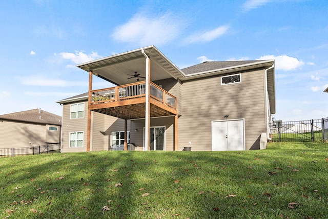 back of house featuring ceiling fan, a lawn, fence, and a wooden deck