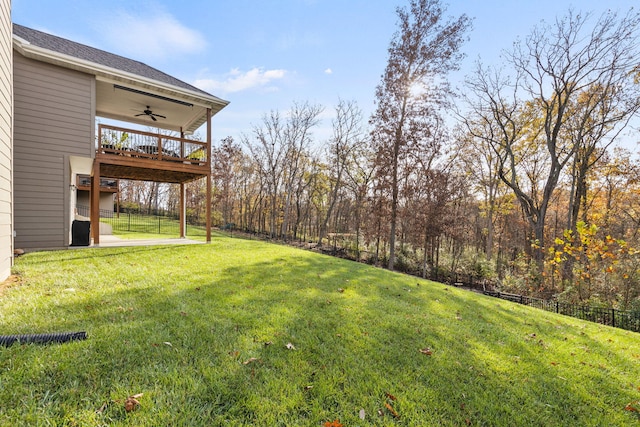 view of yard featuring a patio area, ceiling fan, and a deck