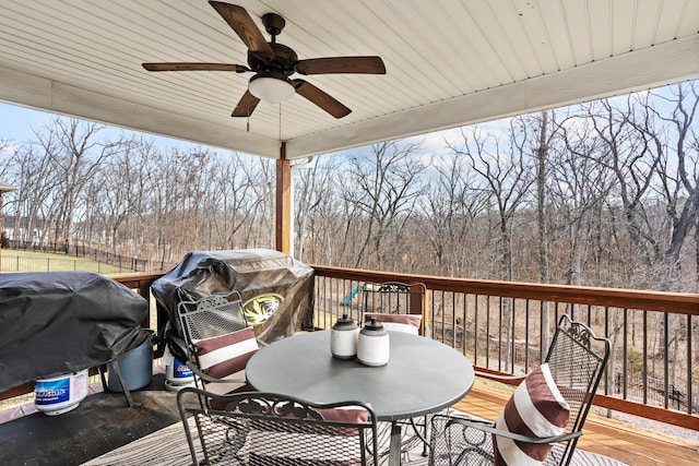 deck featuring outdoor dining space, area for grilling, and a ceiling fan