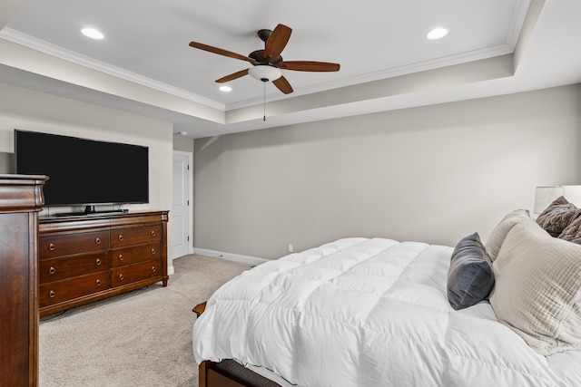 bedroom featuring a tray ceiling, light colored carpet, crown molding, and recessed lighting