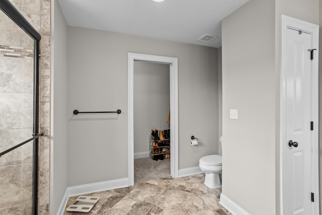 bathroom with toilet, baseboards, visible vents, and a shower stall