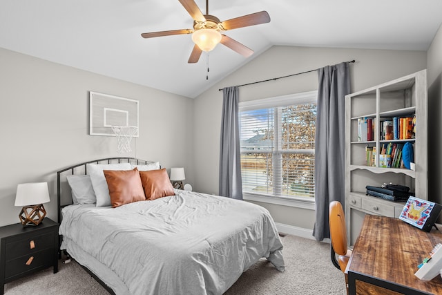 carpeted bedroom with vaulted ceiling, baseboards, and ceiling fan