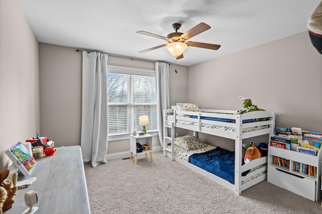 carpeted bedroom with a ceiling fan and baseboards