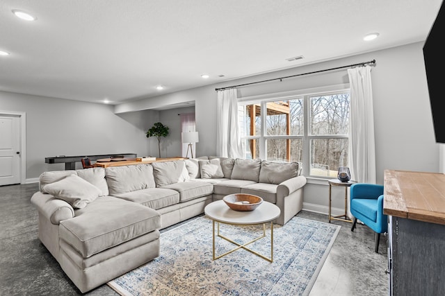 living area with recessed lighting, visible vents, and baseboards