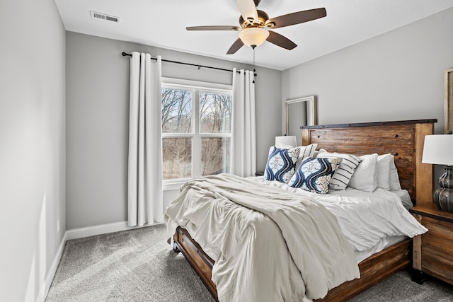 carpeted bedroom with baseboards, visible vents, and ceiling fan