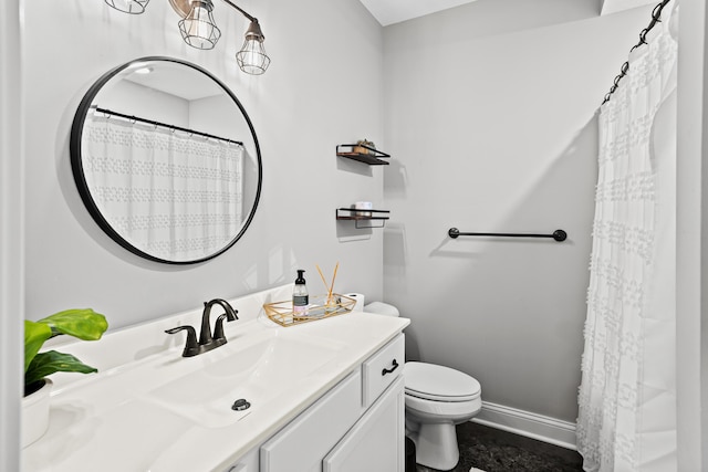 full bathroom featuring toilet, vanity, and baseboards