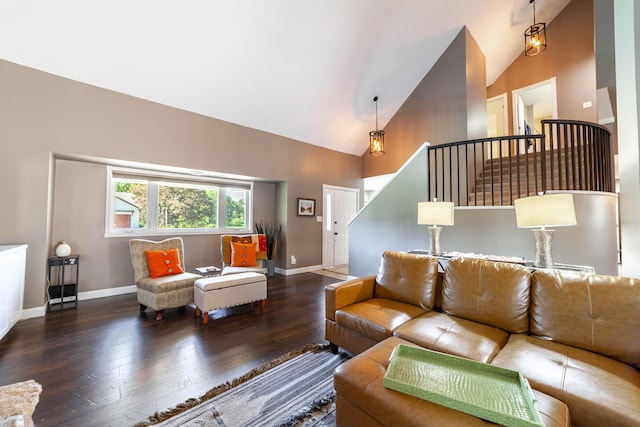 living room featuring baseboards, stairs, high vaulted ceiling, and wood finished floors