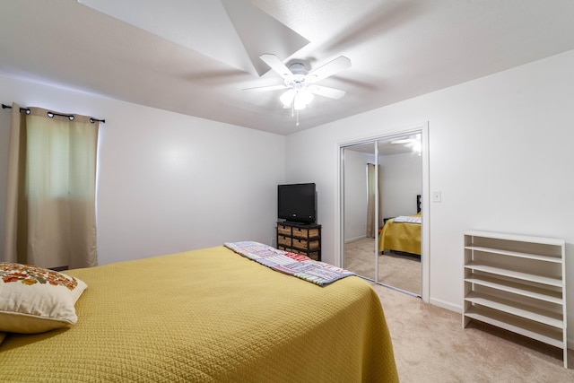 bedroom featuring ceiling fan, baseboards, a closet, and light colored carpet