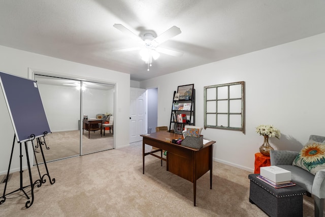 carpeted office featuring ceiling fan and baseboards