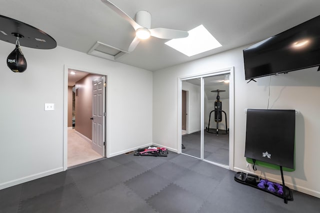 exercise area featuring ceiling fan and baseboards