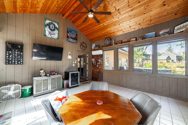 tiled dining area with a ceiling fan, wine cooler, wood ceiling, and lofted ceiling with beams