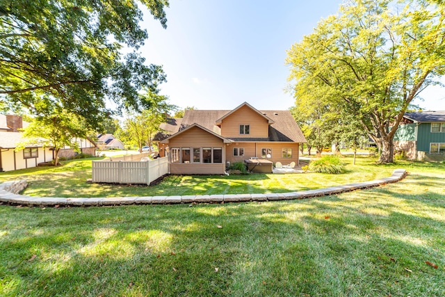 back of house featuring a lawn and fence