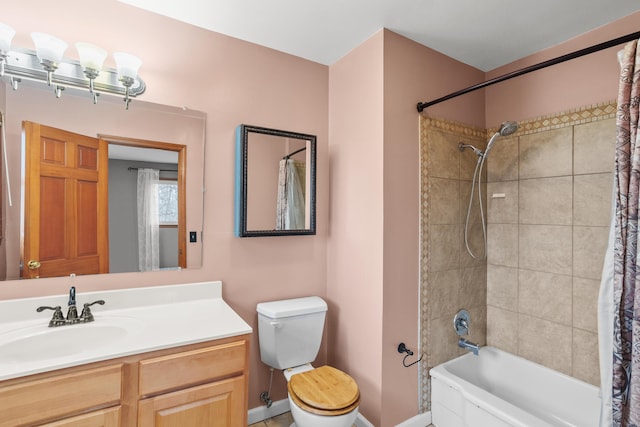 full bathroom featuring shower / tub combo, vanity, toilet, and baseboards