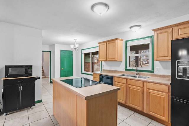 kitchen featuring a center island, light countertops, black appliances, a sink, and light tile patterned flooring