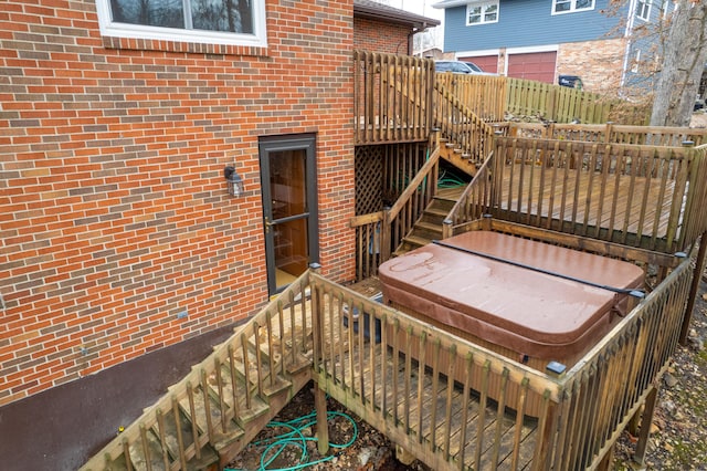 wooden deck featuring stairs and a hot tub