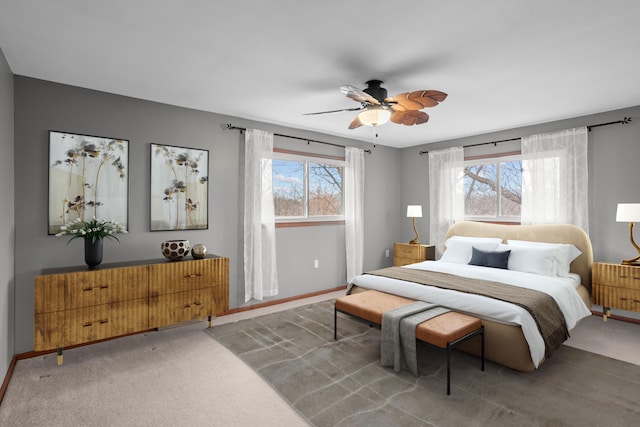 carpeted bedroom featuring baseboards and a ceiling fan