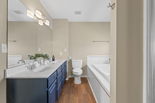 bathroom featuring visible vents, a sink, toilet, and a bath