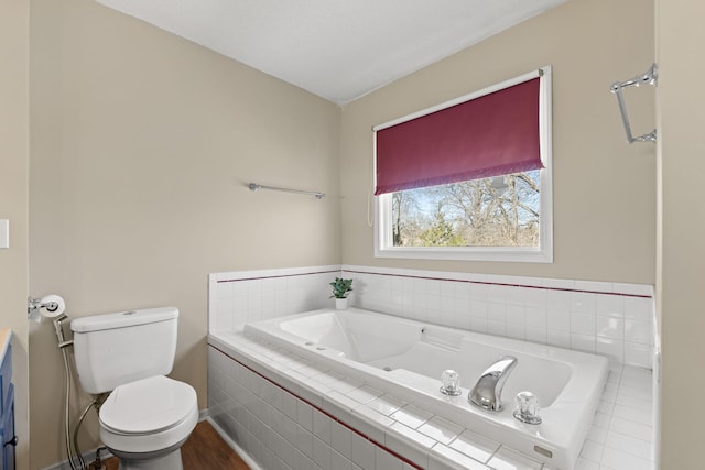 bathroom featuring a garden tub and toilet