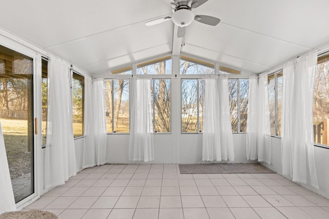 unfurnished sunroom with a ceiling fan and vaulted ceiling