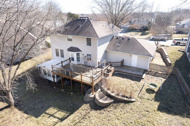 back of property featuring a fenced backyard, a deck, and roof with shingles