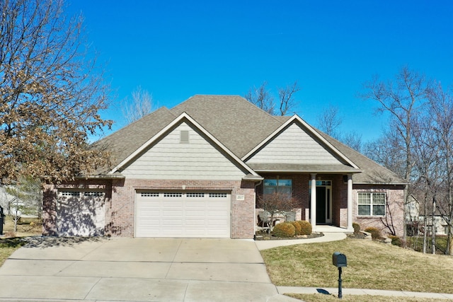 view of front of house with brick siding, roof with shingles, an attached garage, a front yard, and driveway