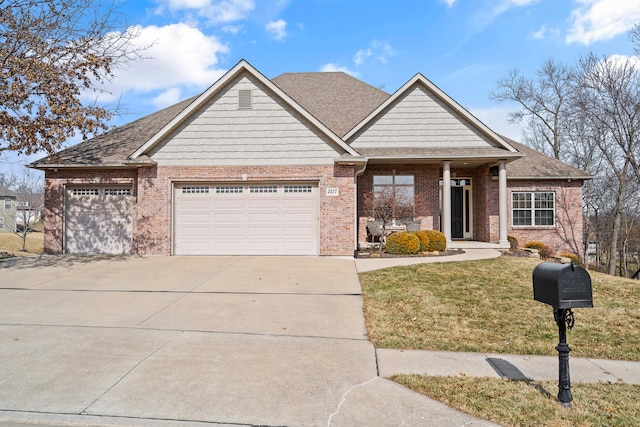 view of front of home featuring a garage, concrete driveway, roof with shingles, a front lawn, and brick siding