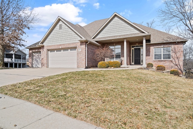 view of front of home with an attached garage, brick siding, a shingled roof, concrete driveway, and a front yard