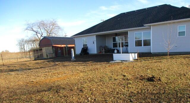 rear view of property with a lawn