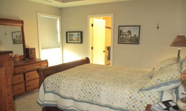 bedroom featuring light carpet