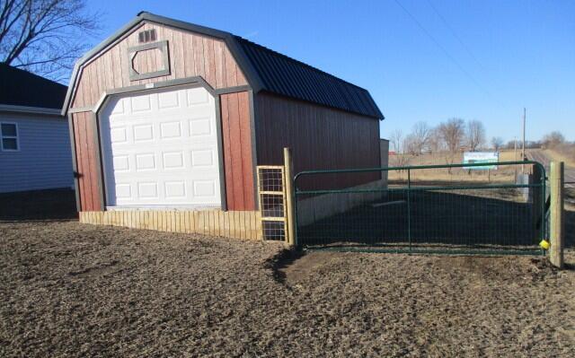 detached garage featuring fence