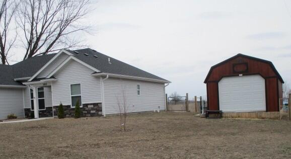 view of home's exterior featuring an outdoor structure and a detached garage