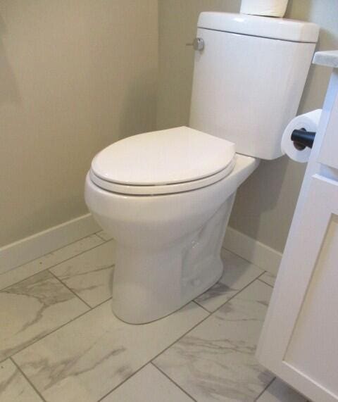 305 E Francis St, Sturgeon, MO 65284 - bathroom featuring marble finish flooring, toilet, and baseboards