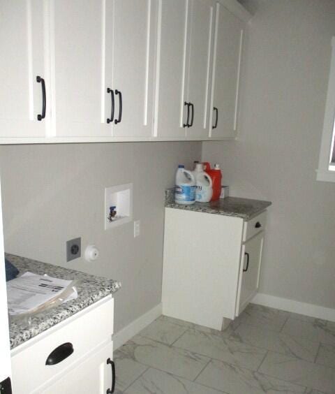 305 E Francis St, Sturgeon, MO 65284 - laundry room featuring cabinet space, washer hookup, electric dryer hookup, and baseboards