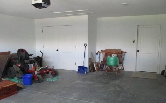 305 E Francis St, Sturgeon, MO 65284 - garage featuring a garage door opener