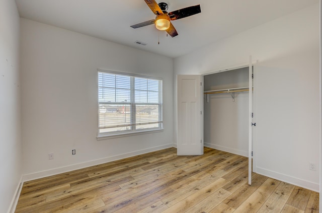 unfurnished bedroom featuring a closet, visible vents, ceiling fan, light wood-type flooring, and baseboards