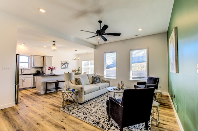 living area featuring light wood finished floors, recessed lighting, a wealth of natural light, and baseboards